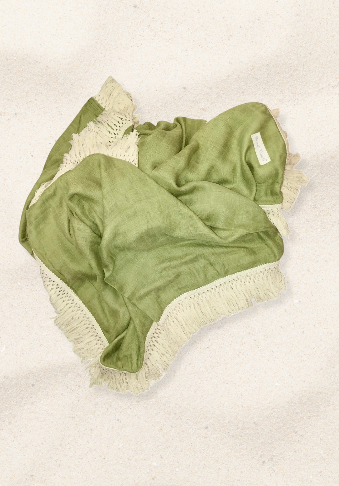 Soft green cotton baby blanket with ivory fringe, made from breathable cotton-bamboo fabric. Lightweight and cozy.