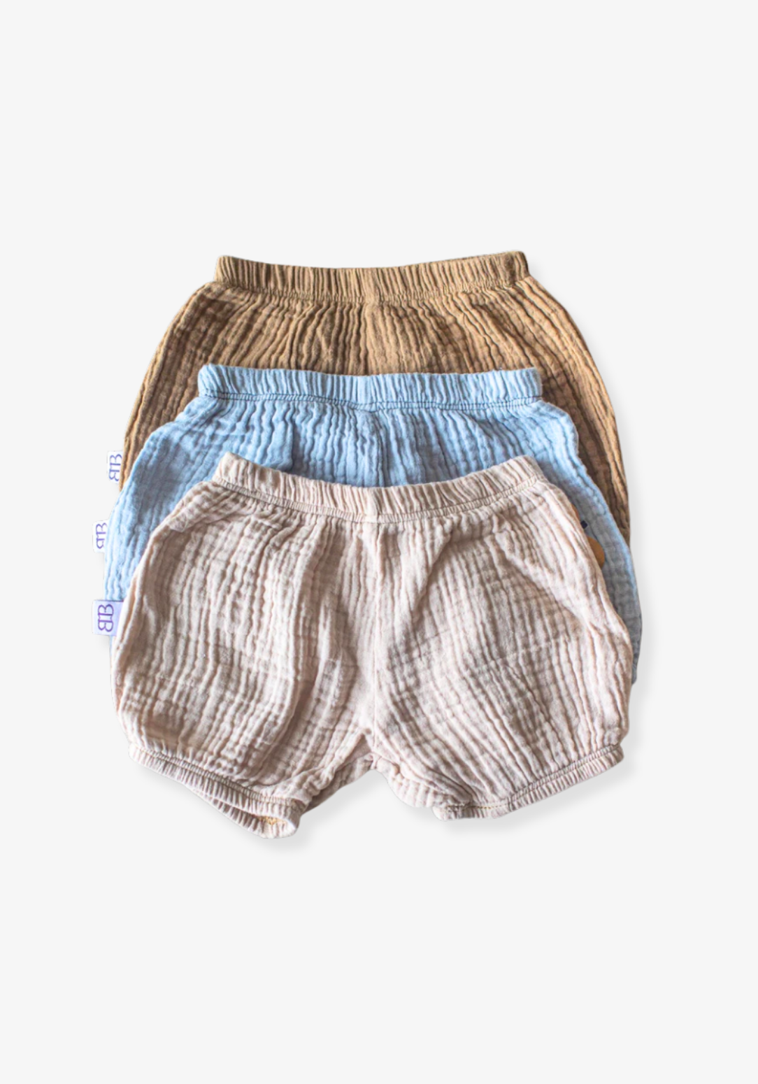 Neutral beige baby bloomers made of breathable organic cotton with gentle elastic trims.