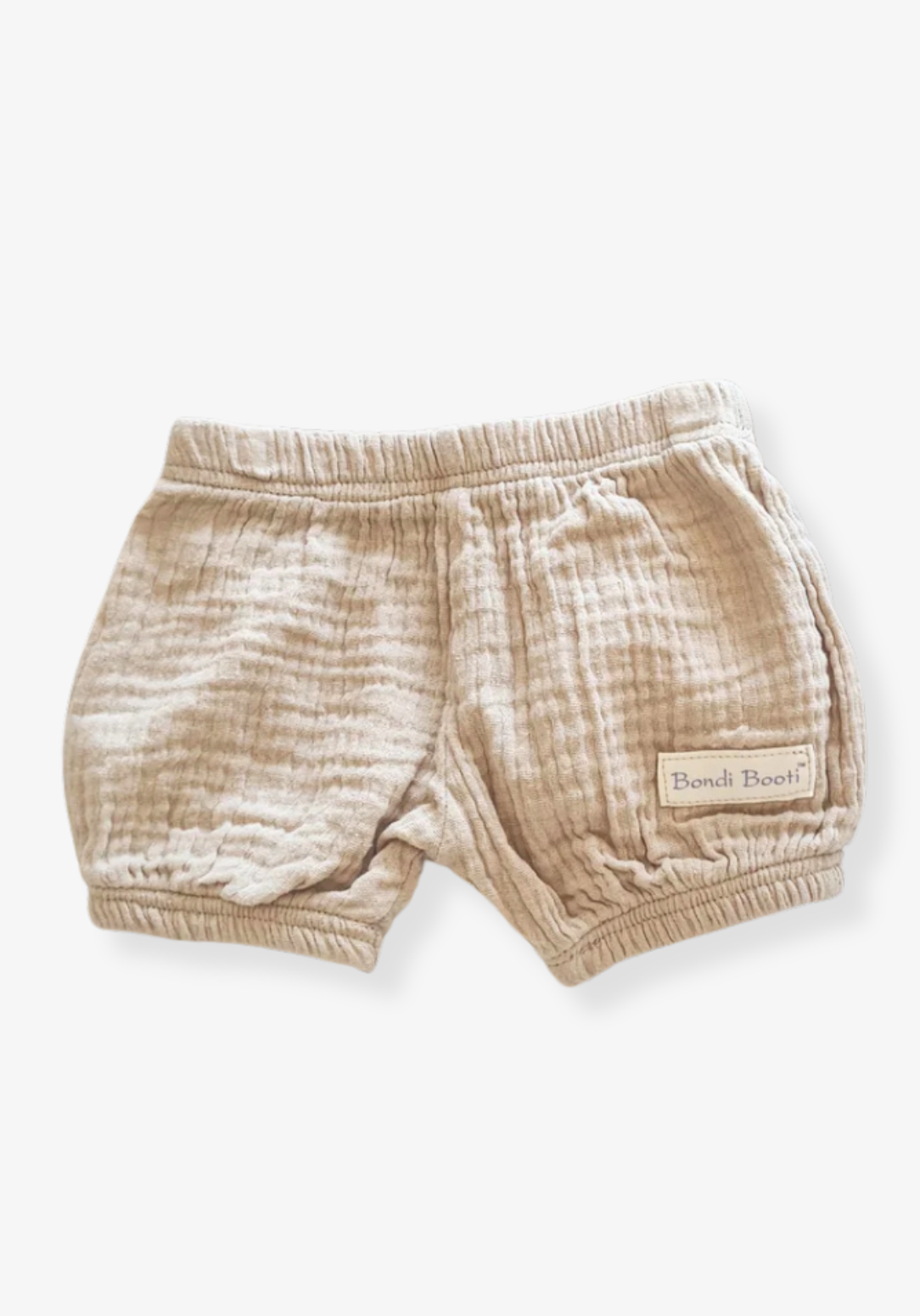 Neutral beige baby bloomers made of breathable organic cotton with gentle elastic trims.