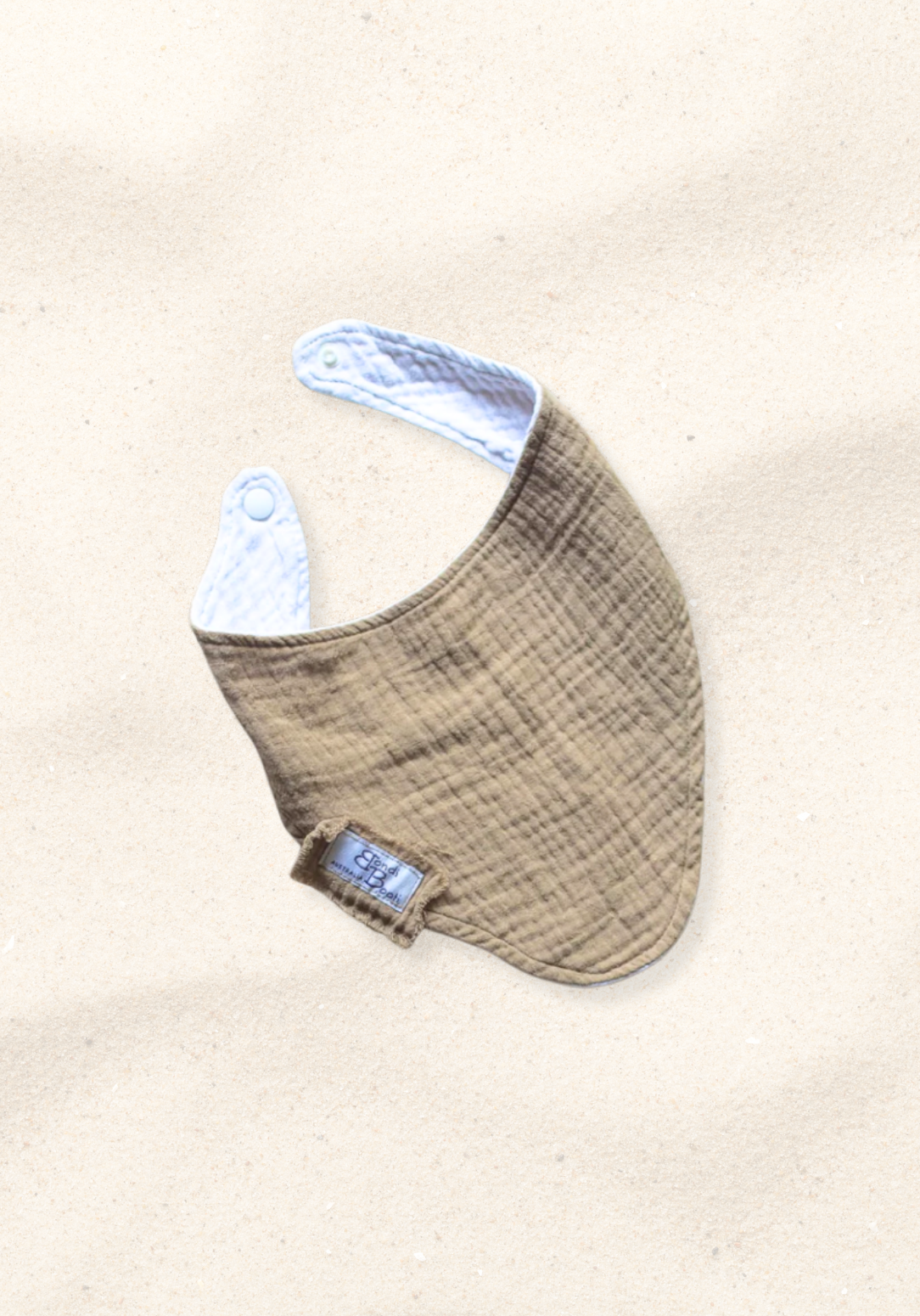 Mocha-toned bandana-style baby bib made of soft organic cotton with absorbent inner lining.