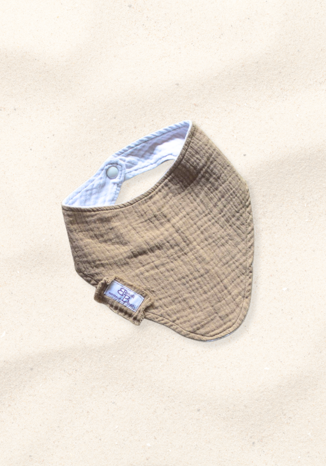 Mocha-toned bandana-style baby bib made of soft organic cotton with absorbent inner lining.