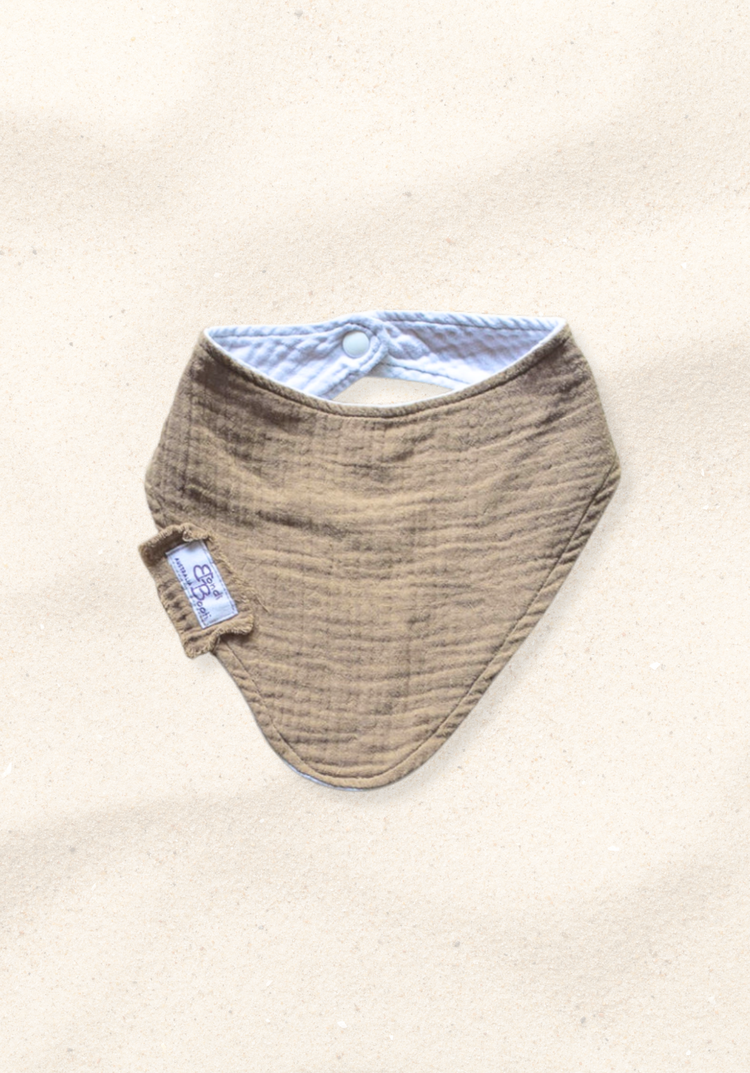 Mocha-toned bandana-style baby bib made of soft organic cotton with absorbent inner lining.