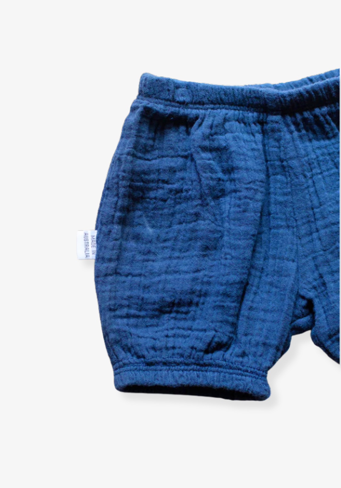 Navy blue organic cotton baby bloomers with soft elastic waist and leg openings.