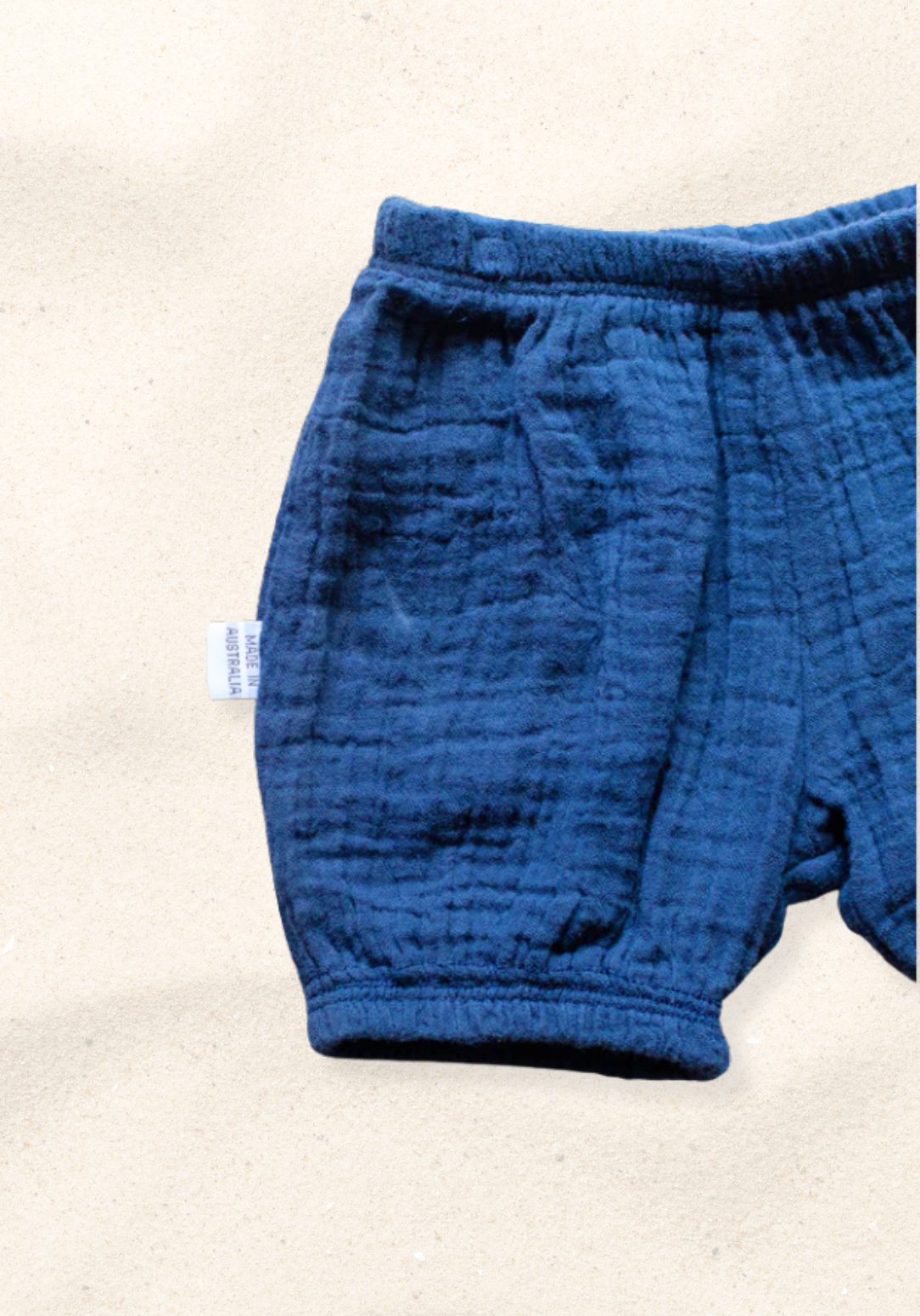 Navy blue organic cotton baby bloomers with soft elastic waist and leg openings.