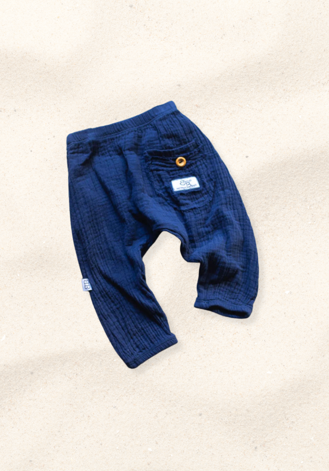 Toddler harem pants in navy blue made from organic cotton with an elastic waistband and buttoned pocket