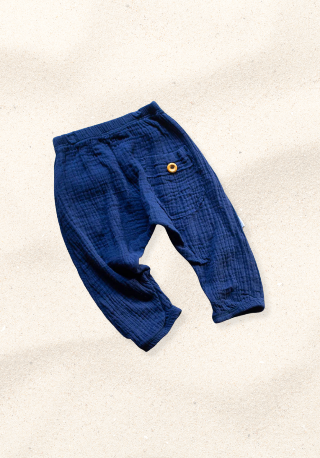 Toddler harem pants in navy blue made from organic cotton with an elastic waistband and buttoned pocket