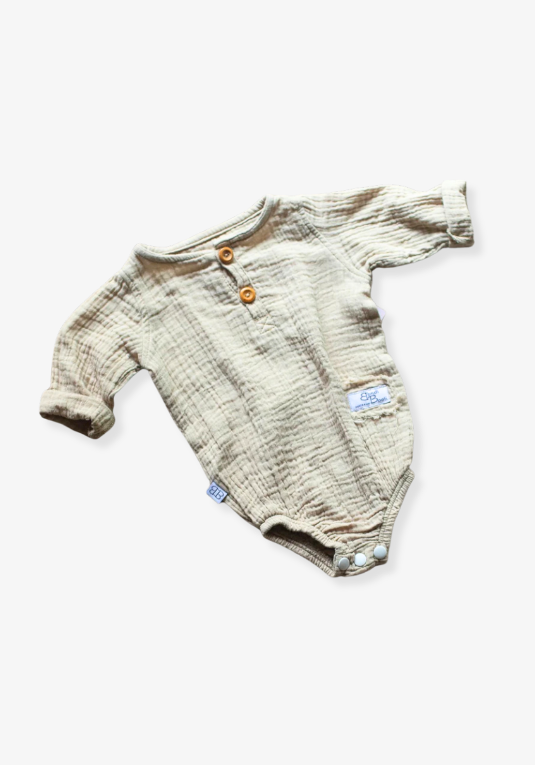 Organic cotton baby romper in beige with long sleeves and button-down front, displayed on a grey background