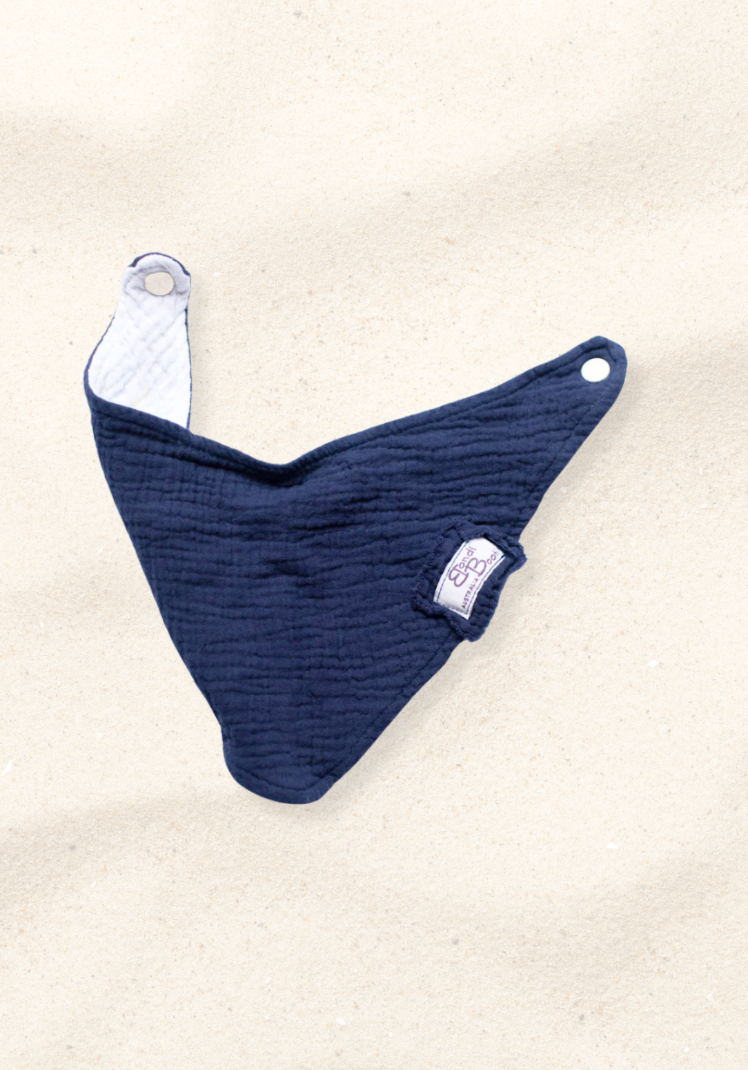 Soft navy organic cotton baby bandana bib with absorbent inner lining and adjustable snap.